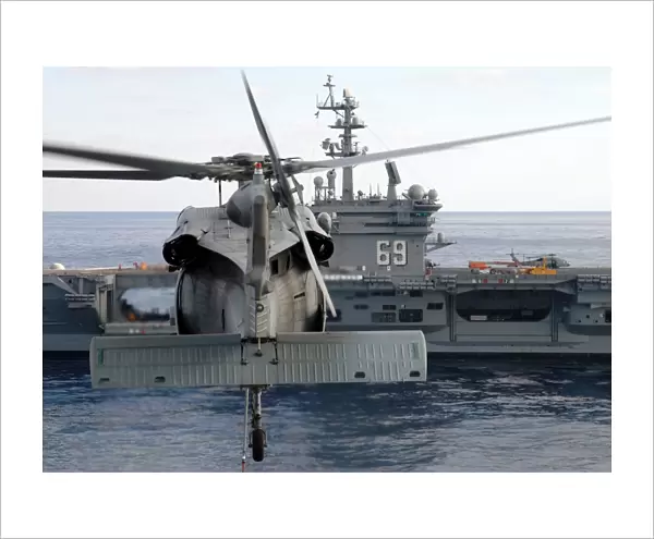 An MH-60S Seahawk hovers prior to taking a load of ammunition to USS Dwight D. Eisenhower