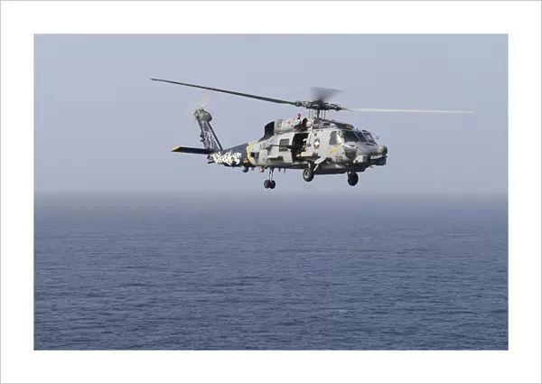An MH-60R Sea Hawk helicopter flies over the Gulf of Oman