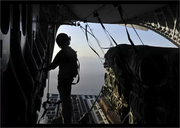U. S. Air Force loadmaster preparing to release a container delivery system over Afghanistan