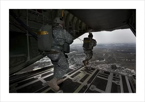 Soldiers jump from a C-130 aircraft over Germany