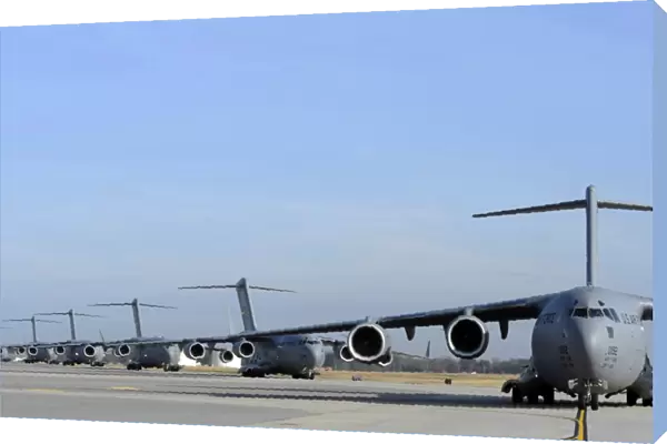 A Formation of U. S. Air Force C-17 Globemaster IIIs prepare for departure