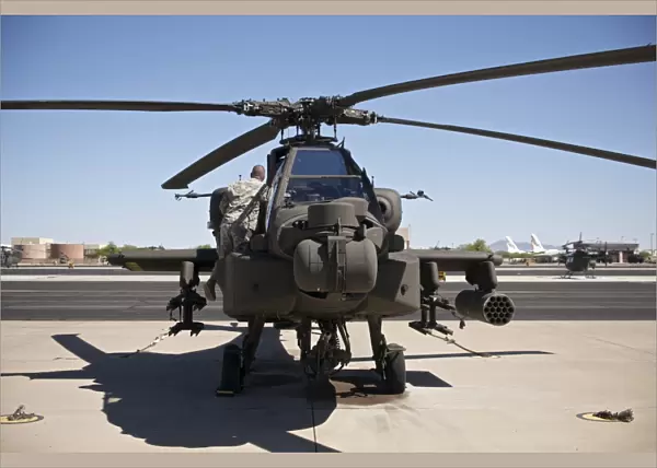 Crew chief working on an AH-64D Apache Longbow