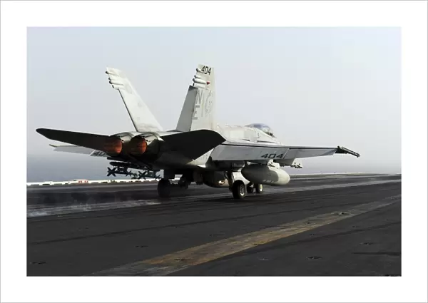 An F  /  A-18C Hornet launches from the flight deck of USS Abraham Lincoln