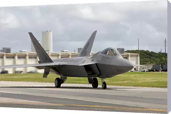 An F-22 Raptor taxis to the end of runway at Kadena Air Base, Japan