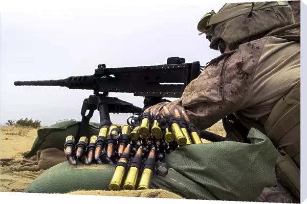 A U. S. Marine fires an M2. 50 caliber machine gun