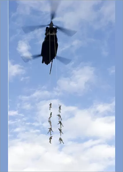 U. S. Soldiers are suspended by a CH-47 Chinook helicopter