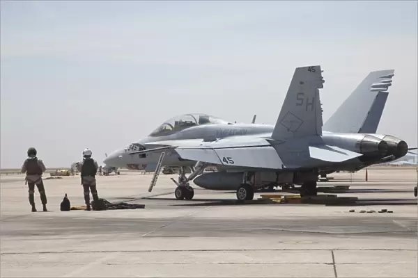 Pilots wait to board their F  /  A-18B Hornet trainer aircraft