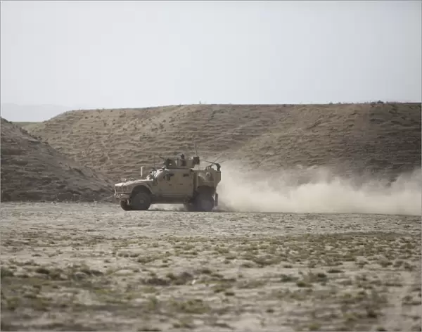 An M-ATV races across the wadi near Kunduz, Afghanistan