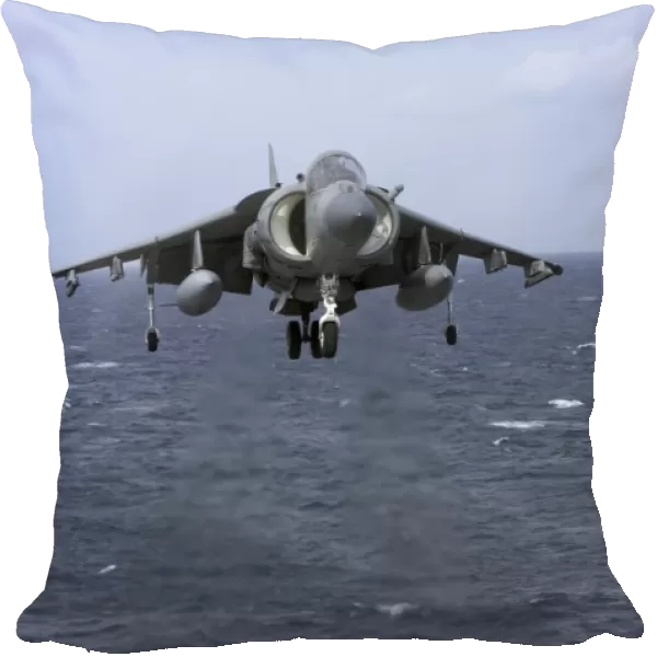 An AV-8B Harrier II prepares to land on the flight deck of USS Nassau
