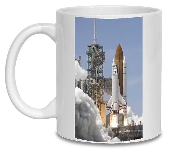 Atlantis twin solid rocket boosters ignite to propel the spacecraft into orbit at