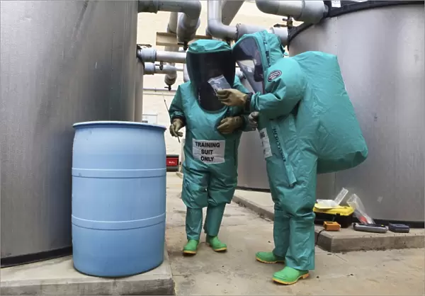 CBRN defense specialists check a barrel for contamination