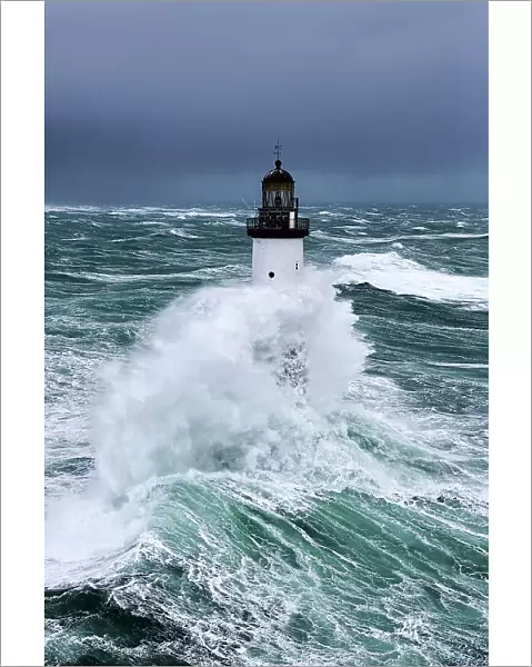 Rough seas at d'Ar-Men lighthouse during Storm Ruth, Ile de Sein, Armorique Regional Park. Iles du Ponant, Finistere, Brittany, France, Iroise Sea. 8th February 2014
