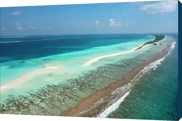 Aerial view along reef and sandbank to Dhigurah island, South Ari Atoll, Maldives, Indian Ocean. February, 2020