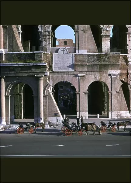 View of the Colosseum with cabs in front
