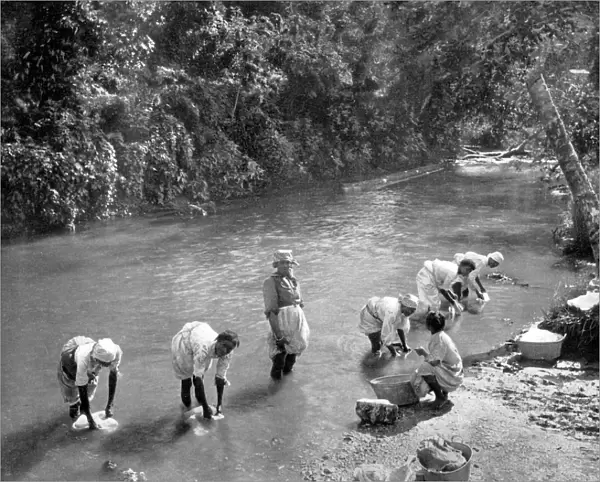 Women washing clothes in the river, Port Antonio, Jamaica, c1905. Artist: Adolphe Duperly & Son