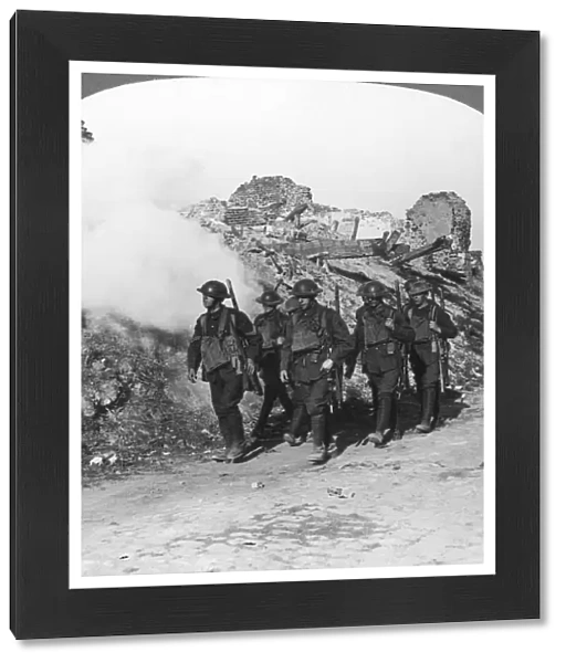 Troops passing the ruins of Monchy on the way up the line, France, World War I, c1914-c1918. Artist: Realistic Travels Publishers