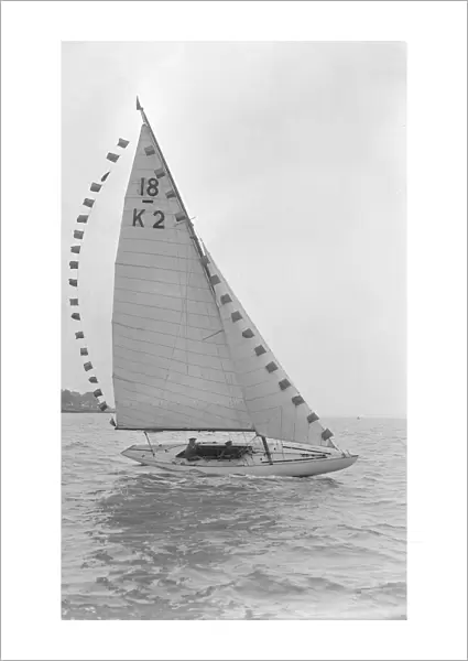 The 18-foot keelboat Prudence (K2) with prize flags, 1922. Creator: Kirk & Sons of Cowes