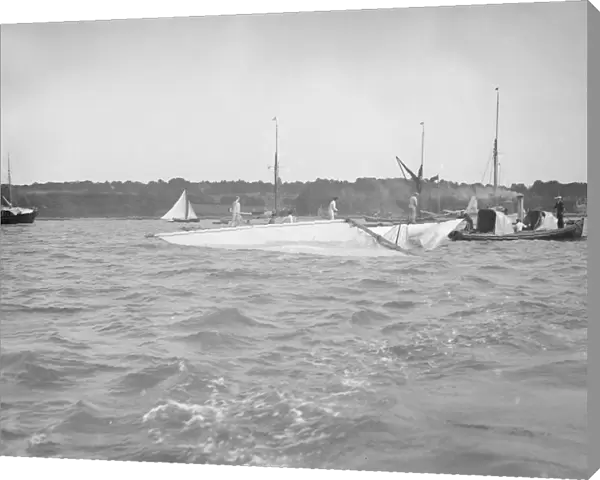 The dismasted sailing yacht Clio is attended to by rescue boats, 1912. Creator