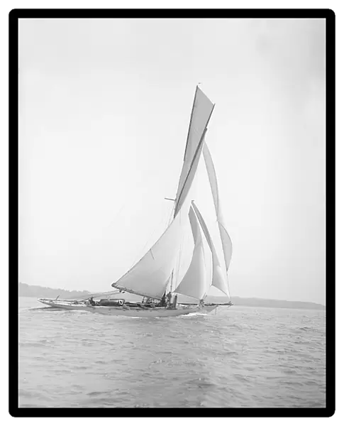 The 40-rater cutter Carina sailing on a reach, 1911. Creator: Kirk & Sons of Cowes