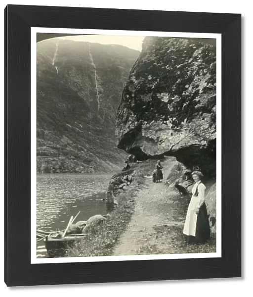 Where the road creeps under the jutting cliffs by the waters of the Nerofjord, Norway, c1905