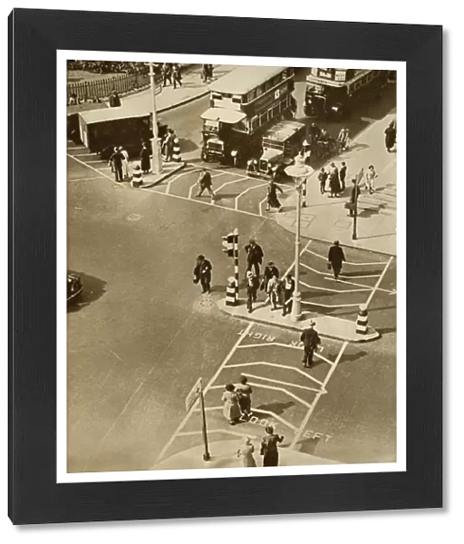 Traffic and pedestrians in Trafalgar Square, London, 1935. Creator: Unknown