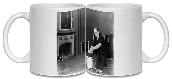 Edward, Lord Montagu of Beaulieu scrubbing floors in Palace House 1952. Creator: Unknown