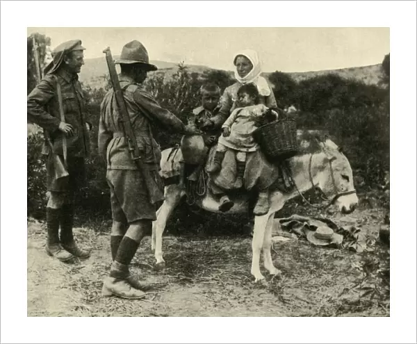 Australian soldier giving water to a Turkish family, First World War, 1915-1916, (c1920)