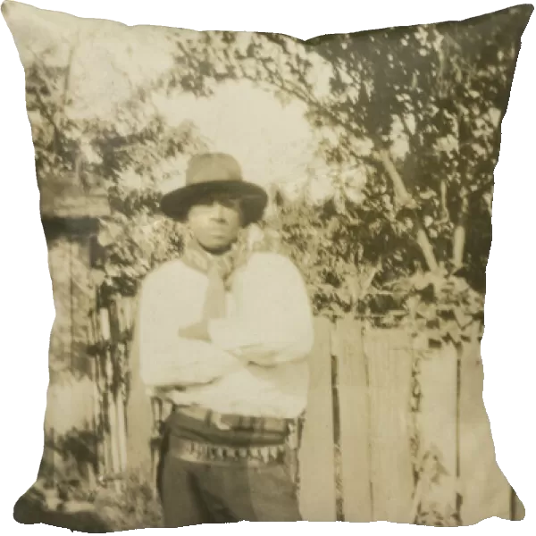 Photographic portrait of a man wearing hat and gun holster, early 20th century