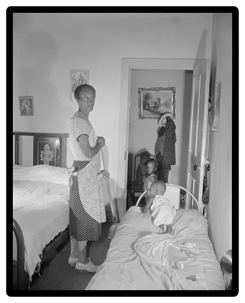 Grandchild of Mrs. Ella Watson, a government charwoman, taking her... nap, Washington, D.C, 1942. Creator: Gordon Parks