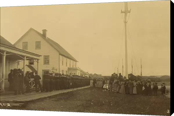Sailors standing in line on boardwalk with a group of local women and men standing... 1894 or 1895. Creator: Alfred Lee Broadbent