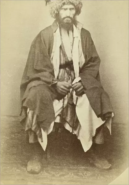 Full-length portrait of man, seated, facing front, between 1870 and 1886. Creator: Unknown