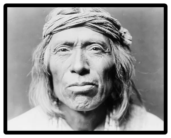 Head-and-shoulders portrait of Shiwawatiwa, a Zuni Indian, facing front, c1903. Creator: Edward Sheriff Curtis