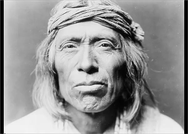 Head-and-shoulders portrait of Shiwawatiwa, a Zuni Indian, facing front, c1903. Creator: Edward Sheriff Curtis
