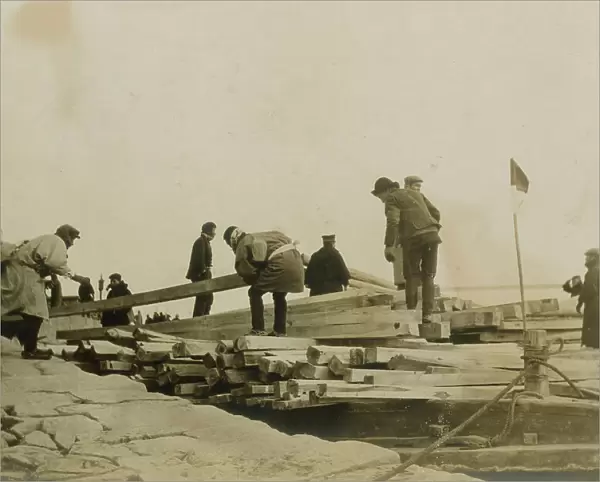Japanese removing timbers from lighters at Chemulpo for erection of runways, c1904. Creator: Robert Lee Dunn