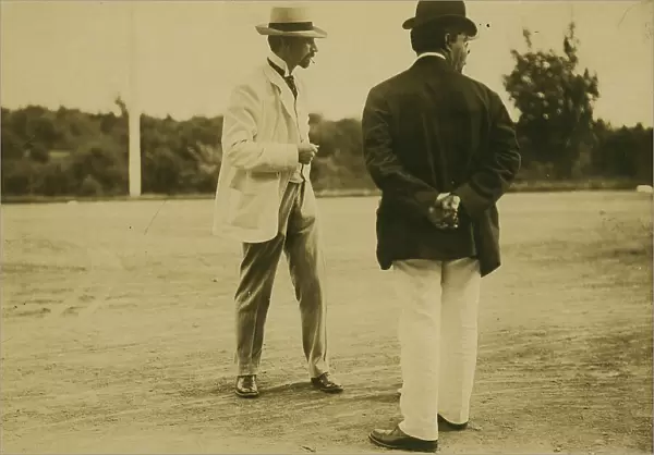 Two men, probably journalists, standing on a field, 1905. Creator: Unknown