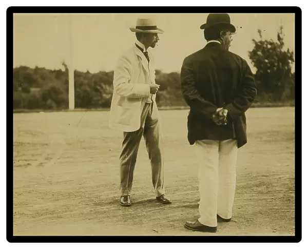 Two men, probably journalists, standing on a field, 1905. Creator: Unknown
