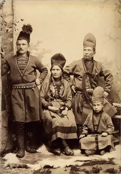 Group picture with four people wearing Sami folk costumes, 1912. Creator: Helene Edlund