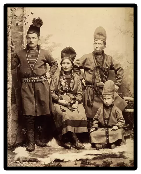 Group picture with four people wearing Sami folk costumes, 1912. Creator: Helene Edlund