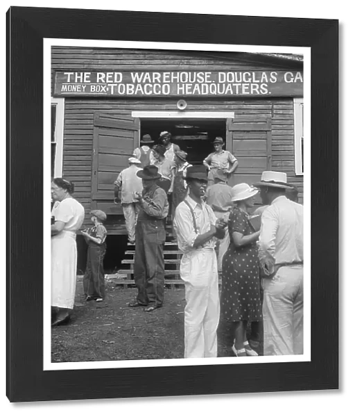 As the auctioneer knocks down the last bid on each basket of tobacco... Douglas, Georgia, 1938. Creator: Dorothea Lange