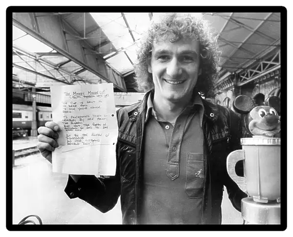Liverpool Footballer Phil Thompson with the Mickey Mouse Cup and letter presented to him before League Cup final by Everton fan