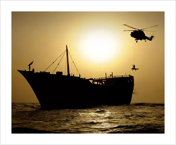 Royal Navy Helicopter Lowering Winchman onto Vessel in Gulf