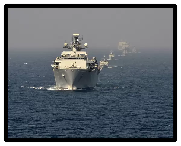 The Fleet Flagship of the Royal Navy, HMS Bulwark at sea with multinational vessels