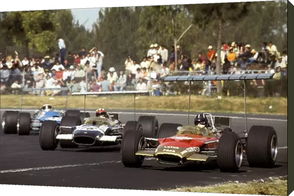 Formula One World Championship: Graham Hill Lotus Cosworth 49B, leads pole position man Jo Siffert in a similar Rob Walker Racing entered car