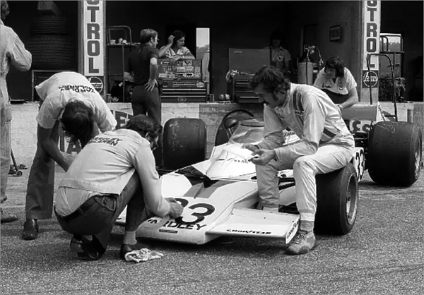 Formula One World Championship: Ninth placed David Hobbs sits on the front tyre of his McLaren M23. It was Davids sixth and final GP