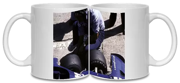 Formula One World Championship: A Tyrrell mechanic checks the tyres on a six-wheeled P34