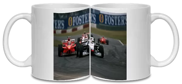 Formula One World Championship: Mika Hakkinen McLaren Mercedes MP4  /  13 leads Michael Schumacher Ferrari F300