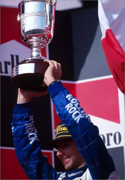 Formula One World Championship: Damon Hill Williams, is presented with the second placed trophy