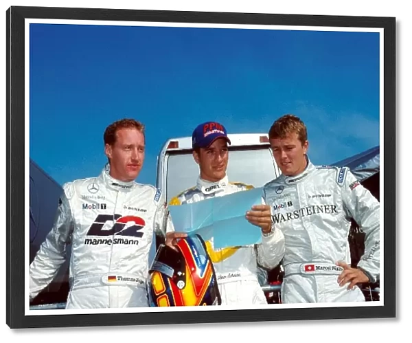 DTM Championship: Timo Scheider, centre, consults with Mercedes drivers Marcel Faessler, right and Thomas Jaeger, left