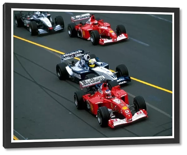 Formula One World Championship: Pole sittter Rubens Barrichello Ferrari F2001 leads at the start of the race from the hard charging Ralf Schumacher