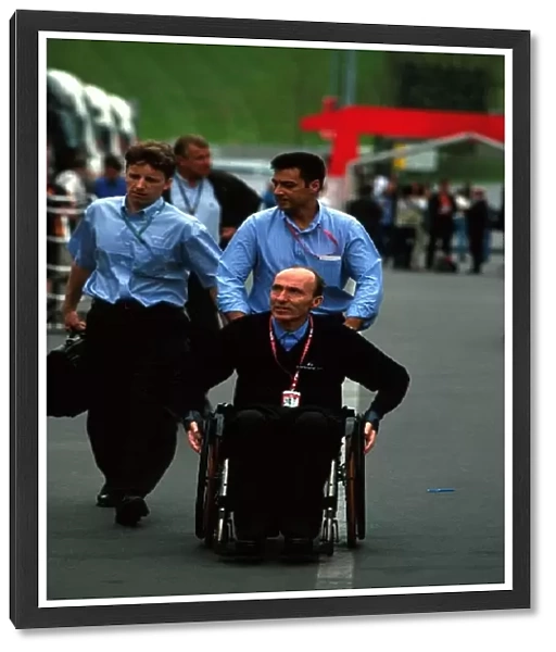 Formula One World Championship: Frank Williams and team personnel in the paddock